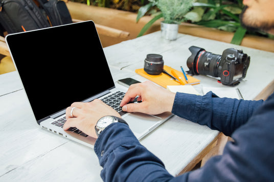 Typing newsletter on laptop